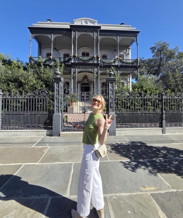Alane Atchley smiling in front of a New Orleans mansion